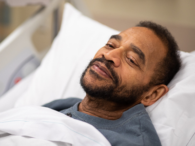 Patient smiling while in bed.